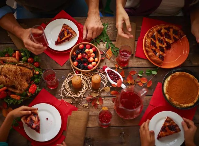 people sitting at table with fall food